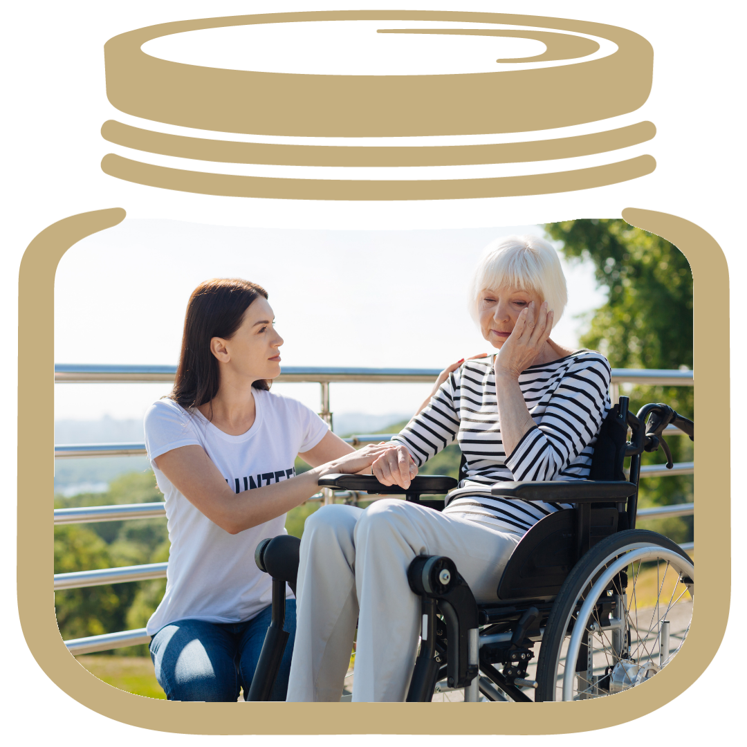 Gold My LifeJar, Inside a young woman in a white shirt is holding the hand of an elderly women in a stripe shirt sitting in a wheelchair