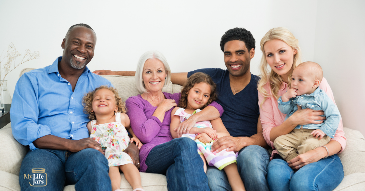 A multigenerational and multiracial family sitting on the couch for a picture for how to write a family history example